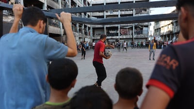 Palestinians watch and play football inside a school sheltering displaced people at the Jabalia refugee camp in northern Gaza. AFP