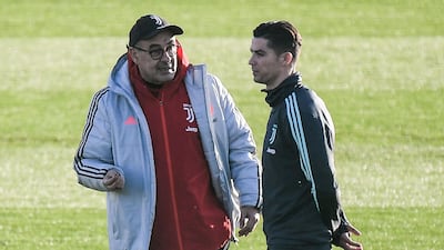 Juventus' coach Maurizio Sarri (L) talks to Portuguese forward Cristiano Ronaldo during a training session at the Continassa Training Ground in Turin. AFP