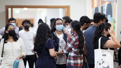 Pupils with their parents arrive to receive their IB results.