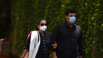 Actress Vidya Balan, left, arrives with her husband and producer Siddharth Roy Kapur at the residence of Indian actor Dilip Kumar to pay their respects, in Mumbai on July 7, 2021.