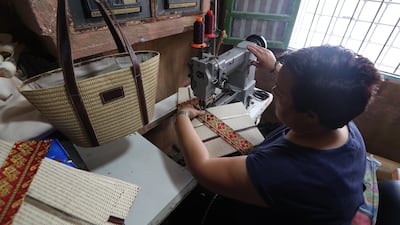 A craftswoman works on a handbag in a workshop in the old town of Tunis, Tunisia. After the end of the coronavirus health emergency and the relaxation of entry conditions for tourists this year, visits are gradually returning to the medina of Tunis.
