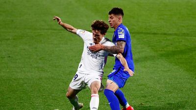 Getafe's Mathias Olivera attempts to tackle Real Madrid's Alvaro Odriozola. Reuters