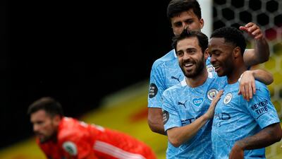 Manchester City's Raheem Sterling, right, celebrates with teammates after scoring his side's second goal. AP