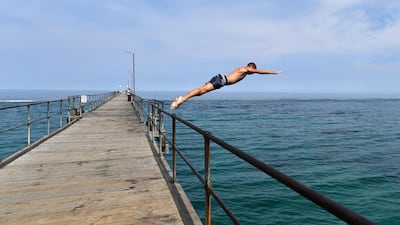 A man jumps from the Port Noarlunga Jetty in the City of Onkaparinga, south of Adelaide, Australia. EPA