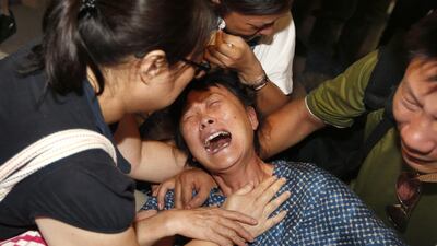 Relatives of a Chinese victim of Monday's bombing cry as families identify and claim the deceased at the Institute of Forensic Medicine in Bangkok on August 18, 2015. Rungroj Yongrit/EPA