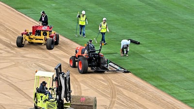 Workers install the pitch at the Houston Stadium in Texas. Reuters