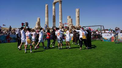 Players from the Let Gaza Live team and the Plastiquas team dance together before their match. Amy McConaghy / The National