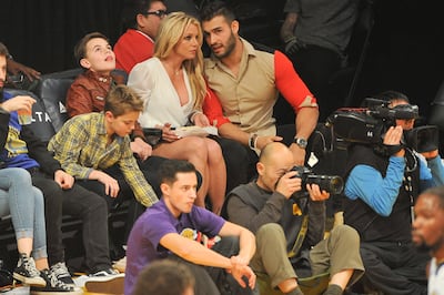 Britney Spears and Sam Asghari attend a 2017 basketball game with the singer's sons Sean Federline and Jayden James Federline. Getty Images