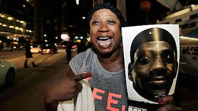 Rosalind Matthews, a Miami fan, holds a sign supporting LeBron James outside the arena where the Heat play.