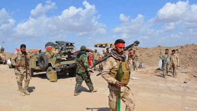 Iraqi government forces and allied militias take position in the northern part of Diyala province, bordering Salaheddin province, as they take part in an assault to retake the city of Tikrit from ISIL militants on March 2, 2015. Younis Al Bayati / AFP