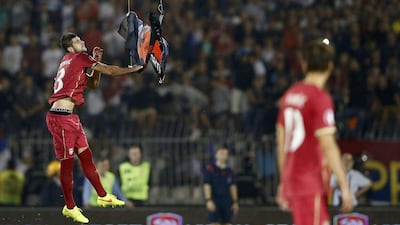 Serbia player Stefan Mitrovic grabs the Albanian flag to tear it down on Tuesday night during the Euro 2016 qualifier between Serbia and Albania. Marko Djurica / Reuters