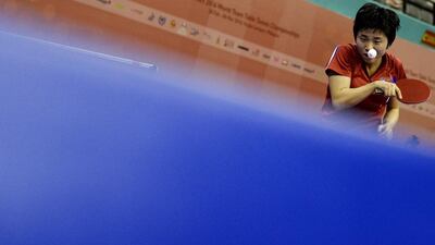 Kim Song-I of North Korea serves against Feng Tianwei of Singapore during their women’s singles quarter-final match at the 2016 World Team Table Tennis Championships in Malaysia. Manan Vatsyayana / AFP Photo