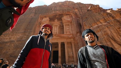 Guides wait for the tourists in front of the treasury site in the ancient city of Petra. Reuters
