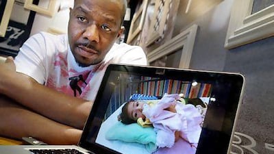 Muneer al Hajri with a picture of his daughter, Meera al Hajri, on his laptop. Delores Johnson / The National