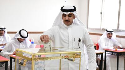 A man casts his vote for National Assembly elections at a religious school in Sabahiya district in Kuwait. AP
