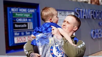 Martyn Hardiman with his son Peter, 2, after purchasing the last club shirt before the store closed. PA