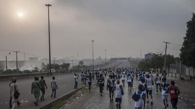 Athletes run on Saturday in the Lagos City Marathon. Stefan Heunis / AFP