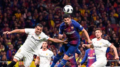 Barcelona forward Luis Suarez, centre, heads the ball during their Copa del Rey final against Sevilla at the Wanda Metropolitano Stadium in Madrid. Pierre-Philippe Marcou / AFP