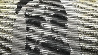 The work is made up of 29,000 reflective discs which have been positioned to vary in colour depending on how the light falls on the metallic surface. Chris Whiteoak / The National