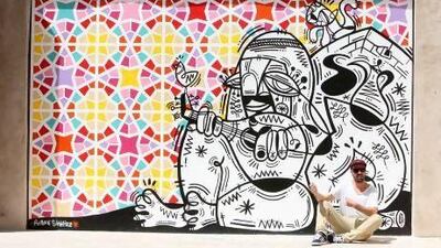 Ruben Sanchez, street artist, with his art work at Bastikiya in Dubai. Pawan Singh / The National