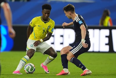 Brazil's Vinicius Jr, left and Scotland's Kieran Tierney battle for the ball. PA