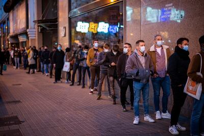 Volunteers line up as they wait to enter a concert in Barcelona, Spain, on December 12. AP