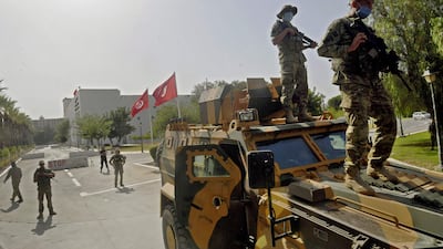 Tunisian military forces guard the area around the parliament building in Tunis on Monday after President Kais Saied suspended parliament and dismissed Prime Minister Hichem Mechichi on Sunday. AFP