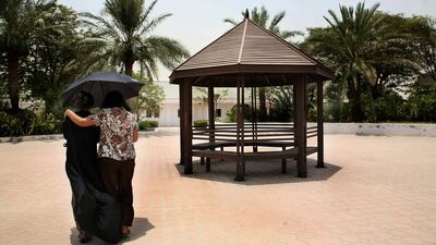 A social worker and a ward of the Dubai Foundation for Women and Children walk in the shelter’s courtyard in July 2008. There has been a 75 per cent decline in the number of human-trafficking victims. Nicole Hill / The National