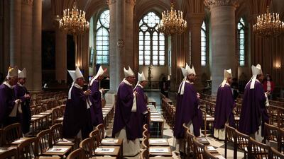 Prelates walk as they prepare to pay their respects to France's late Cardinal and former Paris archbishop Andre Vingt-Trois during his funeral ceremony at the Notre-Dame de Paris Cathedral in Paris on July 23, 2025. Cardinal Andre Vingt-Trois, who was archbishop of Paris between 2005 and 2017, died on July 18, 2025, at the age of 82. (Photo by Thibaud MORITZ / AFP)