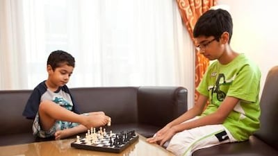 Shayaan Qureshi, 5, a Pakistani boy living in Bahrain and born without arms, plays a game of chess with his brother Sheheryar on a visit to Dubai to meet a support group for children with special needs.