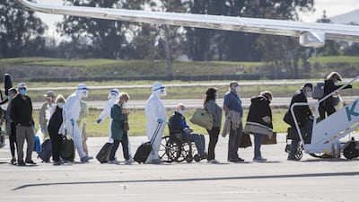 Passengers who were on the Carnaval Corp. Grand Princess cruise ship board a chartered plane at the Oakland International Airport in Oakland, California, US, on Wednesday, March 11, 2020. Bloomberg
