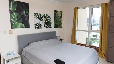 The bright bedroom has views of the Dubai Canal