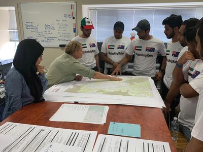 Sultan Al Neyadi, wearing the UAE baseball cap, has travelled to Australia to help with efforts tackling bushfires