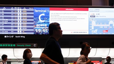 Passengers gather to check flight information at Haneda Airport in Tokyo. EPA