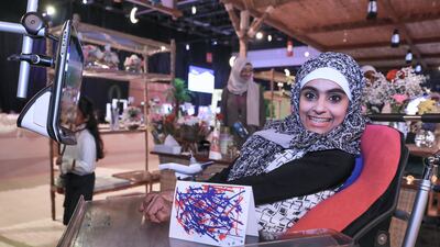 Huda Alkabi from Zayed Higher Education proudly shows her digital graphic art. Victor Besa / The National