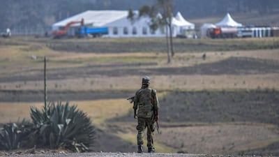 A security personnel patrols near near the crash site of flight ET302 for the commemoration of the first anniversary in Tulu Fara, Ethiopia. AFP