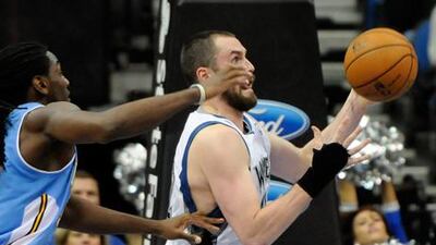 Minnesota's Kevin Love shields the ball from Denver's Kenneth Faried in his first game back from injury