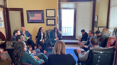 Ms Bayat, centre, participates in a meeting in the US. Photo: Crystal Bayat