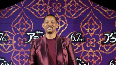 Will Smith, in a burgundy satin suit, attends the 'Aladdin' premiere on May 16, 2019 in Tokyo, Japan. Getty Images