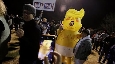 A man wearing an inflatable suit representing Donald Trump poses for a photo during the 'March for Truth: Stop the Wall, Stop the Lies'. Reuters