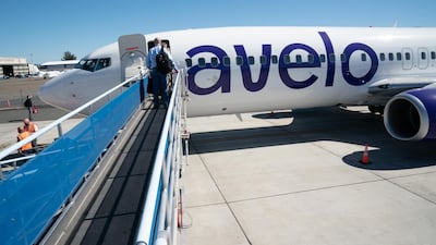 Passengers board an Avelo Airlines flight. Bloomberg
