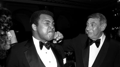 In this April 13, 1981, file photo, sportscaster Howard Cosell, right, is pictured laying one on the chin of former world heavyweight boxing champ Muhammad Ali during a dinner in New York. Richard Drew / AP photo