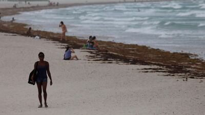 A woman walks along South Beach prior to the arrival of Hurricane Irma to south Florida, in Miami. Carlos Barria / Reuters