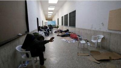 A North African migrant gestures as he waits inside the Ventimiglia train station on the Italian-French border April 21, 2011. France temporarily shut its border to trains from Italy carrying African migrants and protesters on Sunday, a move Rome formally protested, accusing Paris of violating European principles.