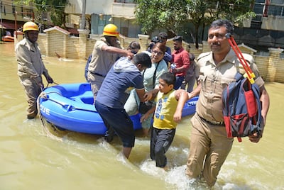 Firefighters rescue people from a flooded area in Bengaluru. AFP