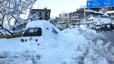 A vehicle is stuck beside a road. An enormous traffic jam was caused when tens of thousands of visitors drove to the hill town, drawn there by the unusually heavy snowfall. AFP