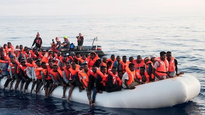Migrants on a rubber boat being rescued by the Lifeline ship in the Mediterranean. Hermine Poschmann / Mission Lifeline via AP