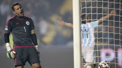 Paraguay goalkeeper Justo Villar reacts after Sergio Aguero, right, scores Argentina's fifth goal in the Copa America semi-final on Tuesday night. Fernando Bizerra Jr / EPA
