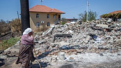 Cemile Gullu cries in front of the burnt remains of her house after a bushfire in Bucak village in the Manavgat district of Antalya, Turkey. EPA
