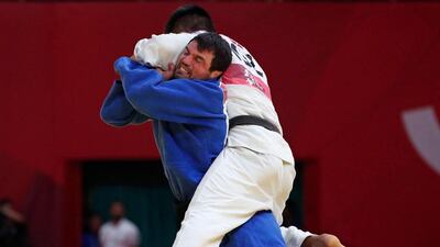 Victor Scvortov of the UAE, in blue, will represent the country at the Tokyo Olympics. Reuters